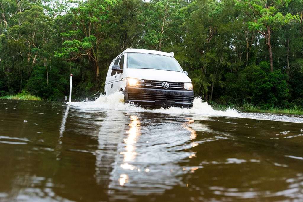 VW T6 Transporter Frontline Campervan drivng through flooded road